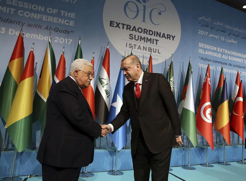 El presidente de Turquía, Recep Tayyip Erdogan, estrecha la mano del presidente de la Autoridad Palestina Mahmoud Abbas en la Cumbre Extraordinaria de la Organización de Cooperación Islámica en Estambul, miércoles 13 de diciembre de 2017. (Yasin Bulbul / Pool Photo via AP)
