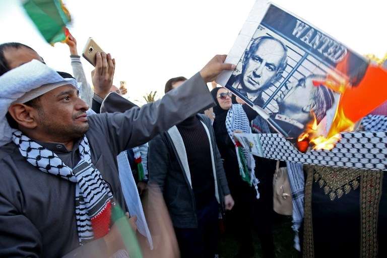 Un manifestante kuwaití quema un cartel del primer ministro israelí Benjamin Netanyahu durante una manifestación frente a la Asamblea Nacional en la ciudad de Kuwait el 9 de diciembre de 2017, contra el reconocimiento del presidente estadounidense Donald Trump de Jerusalén como la capital de Israel. (AFP PHOTO / Yasser Al-Zayyat)
