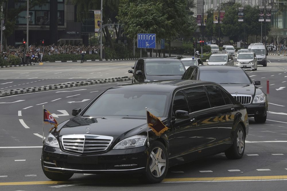 Una limusina, al frente, con una bandera de Corea del Norte que se cree que transporta al líder Kim Jong Un viaja más allá de Orchard Road de Singapur camino al Hotel St Regis cuando llega a Singapur el domingo 10 de junio de 2018. (AP Photo / Joseph Nair)