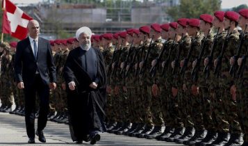 El presidente suizo Alain Berset, izquierda, camina con el presidente iraní Hassan Rouhani mientras revisa una guardia de honor después de su llegada a un aeropuerto en Kloten, Cantón de Zúrich, el 2 de julio de 2018, al comienzo de una visita oficial de dos días a Suiza. (AFP / RUBEN SPRICH)