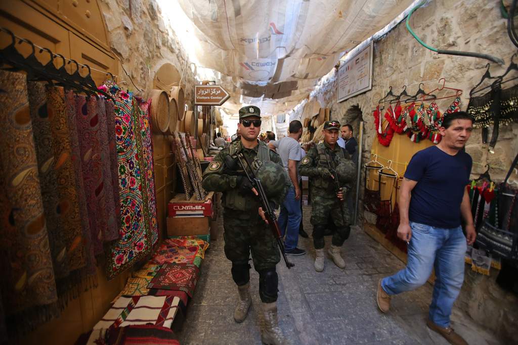 Miembros de las fuerzas de seguridad de la Autoridad Palestina caminando por la Ciudad Vieja de Hebrón (Crédito: Wafa)