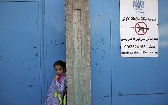 Una niña se encuentra a la entrada de una escuela administrada por la Agencia de las Naciones Unidas para los Refugiados Palestinos (UNRWA) en el campo de refugiados de Balata, al este de Nablus en Cisjordania el 29 de agosto de 2018. (AFP PHOTO / Jaafar ASHTIYEH)