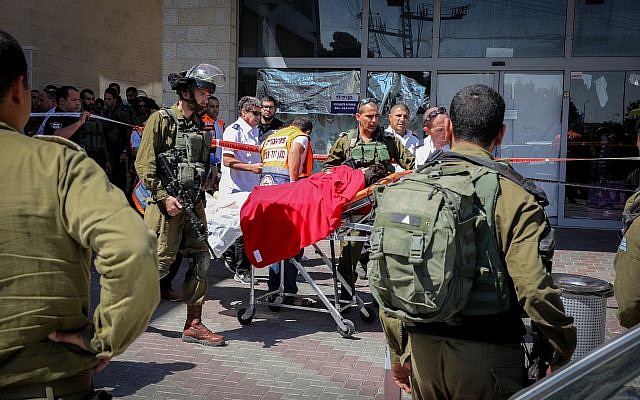Soldados israelíes y médicos en la escena de un atentado terrorista fatal junto al cruce de Gush Etzion en Judea y Samaria el 16 de septiembre de 2018. (Gershon Elinson / Flash90)