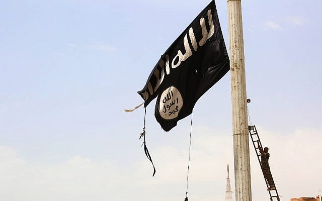 En esta foto de archivo tomada el 30 de abril de 2017, un miembro de las Fuerzas Democráticas Sirias respaldadas por los Estados Unidos retira una bandera del Estado Islámico en la ciudad de Tabqa, a unos 55 kilómetros (35 millas) al oeste de los jihadistas, y luego capital de facto de Raqqa. (Foto de AFP / Delil Souleiman)