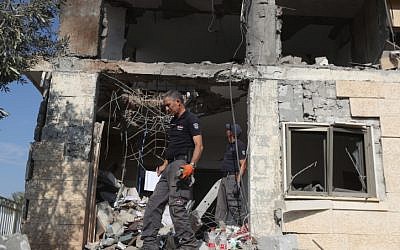 Las fuerzas de seguridad israelíes inspeccionan un edificio que fue alcanzado por un cohete disparado desde la Franja de Gaza en la ciudad de Beersheba, sur de Israel, el 17 de octubre de 2018. (Yonatan Sindel / Flash90)