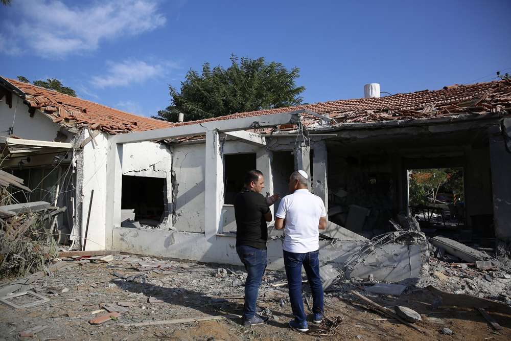 Los funcionarios evalúan el daño a una casa después de que fue golpeada por un cohete disparado por terroristas palestinos desde la Franja de Gaza, en la ciudad de Ashkelon, Israel, al sur de Israel, el 13 de noviembre de 2018. (AP Photo / Ariel Schalit)