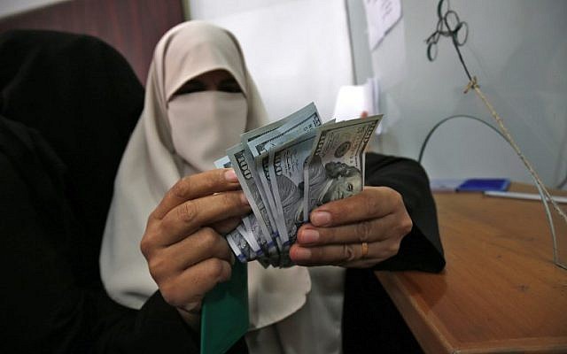 Una mujer palestina cuenta su dinero luego de recibir su salario en Rafah, en el sur de la Franja de Gaza, el 9 de noviembre de 2018. (Said Khatib / AFP)