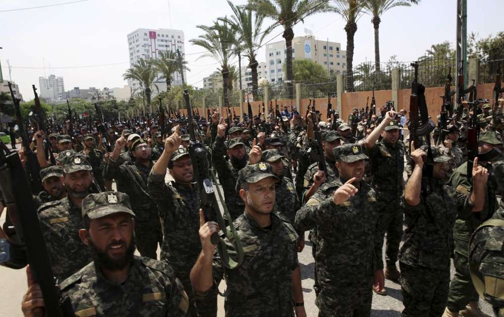 Oficiales de Hamas corean consignas islámicas mientras sostienen sus rifles durante un desfile contra los arreglos de seguridad israelíes en el Monte del Templo, frente al Consejo Legislativo Palestino en la ciudad de Gaza, el miércoles 26 de julio de 2017. (Foto AP / Adel Hana)