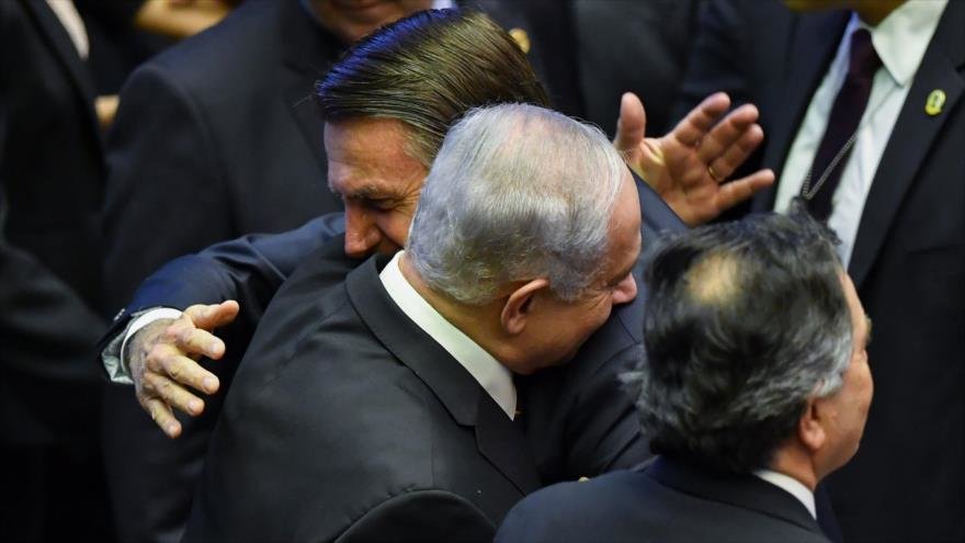 El recién juramentado presidente de Brasil, Jair Bolsonaro (C), saluda al primer ministro Benjamin Netanyahu (L), durante su ceremonia de inauguración, en el Congreso Nacional de Brasilia el 1 de enero de 2019. (Nelson Almeida / AFP)