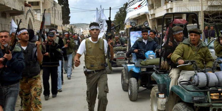 Zakaria Zubeidi, el comandante local del ala militar de Fatah, las Brigadas de los Mártires de Al-Aqsa y otros hombres armados marchan por las calles de la ciudad de Jenin en Cisjordania el 2 de abril de 2005. (Mohammed Ballas / AP Photo)