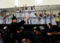 Illustrative: Supporters of the Muslim Brotherhood and other Islamists gesture from the defendants cage as they receive sentences in a mass trial in Alexandria, Egypt, May 19, 2014. (AP Photo/Heba Khamis)