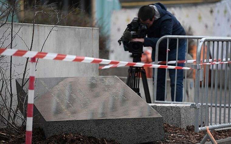 Un camarógrafo filma la piedra conmemorativa que marca el sitio de la Sinagoga Vieja de Estrasburgo, que fue destruida por los nazis en la Segunda Guerra Mundial, después de que fue destruida durante la noche del 2 de marzo de 2019 en Estrasburgo, este de Francia. (FREDERICK FLORIN / AFP)