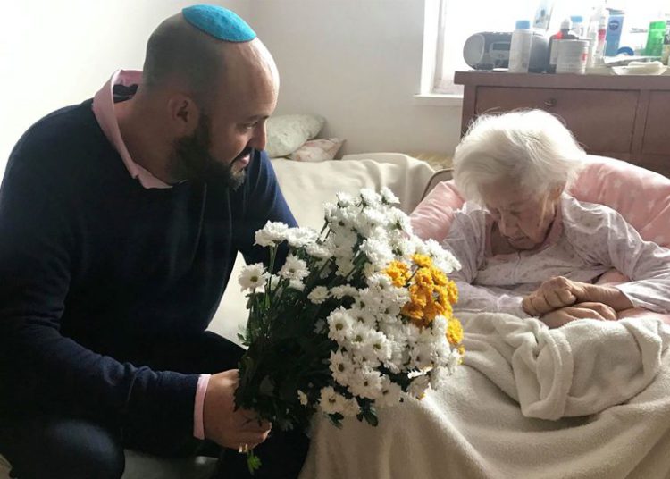 Krystyna Danko recibió flores de Jonny Daniels en su apartamento en Varsovia, Polonia, en su 102 cumpleaños, el 9 de julio de 2019. (De las Profundidades a través de JTA)