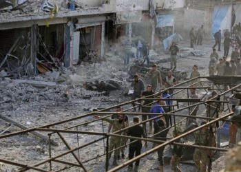 Combatientes sirios respaldados por Turquía inspeccionan el sitio de una explosión de coche bomba en la ciudad kurda de Tal Abyad, en el norte de Siria, en la frontera con Turquía, el 2 de noviembre de 2019. (Bakr Alkasem / AFP)