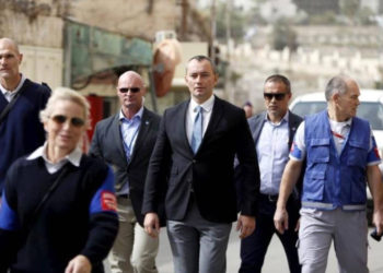 Nickolay Mladenov (C), the United Nations Secretary-General Special Representative to the Middle East, looks at Israeli soldiers during his visit to the West Bank city of Hebron November 4, 2015.. (photo credit: REUTERS)