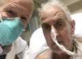 In this photo provided by the University of Maryland School of Medicine, Dr. Bartley Griffith takes a selfie photo with patient David Bennett in Baltimore in January 2022. In a medical first, doctors transplanted a pig heart into Bennett in a last-ditch effort to save his life and the hospital said Monday, Jan. 10, 2022 that he’s doing well three days after the highly experimental surgery. (Dr. Bartley Griffith/University of Maryland School of Medicine via AP)