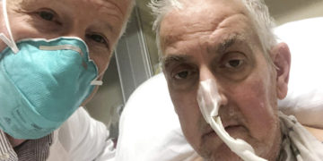 In this photo provided by the University of Maryland School of Medicine, Dr. Bartley Griffith takes a selfie photo with patient David Bennett in Baltimore in January 2022. In a medical first, doctors transplanted a pig heart into Bennett in a last-ditch effort to save his life and the hospital said Monday, Jan. 10, 2022 that he’s doing well three days after the highly experimental surgery. (Dr. Bartley Griffith/University of Maryland School of Medicine via AP)