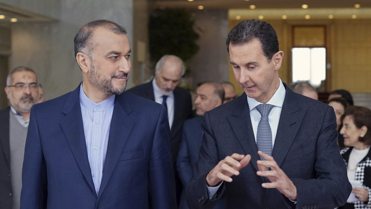 En esta foto publicada por la agencia de noticias oficial siria SANA, el presidente sirio Bashar Assad, a la derecha, habla con el ministro de Asuntos Exteriores de Irán, Hossein Amir-Abdollahian, el 23 de marzo de 2022, en Damasco, Siria. (SANA vía AP)