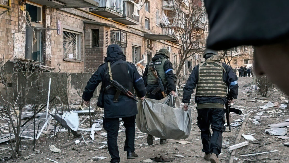 Policías ucranianos sacan un cuerpo de un edificio residencial de cinco pisos que se derrumbó parcialmente tras un bombardeo en Kiev el 18 de marzo de 2022, mientras las tropas rusas intentan rodear la capital ucraniana como parte de su lenta ofensiva (Sergei SUPINSKY / AFP)