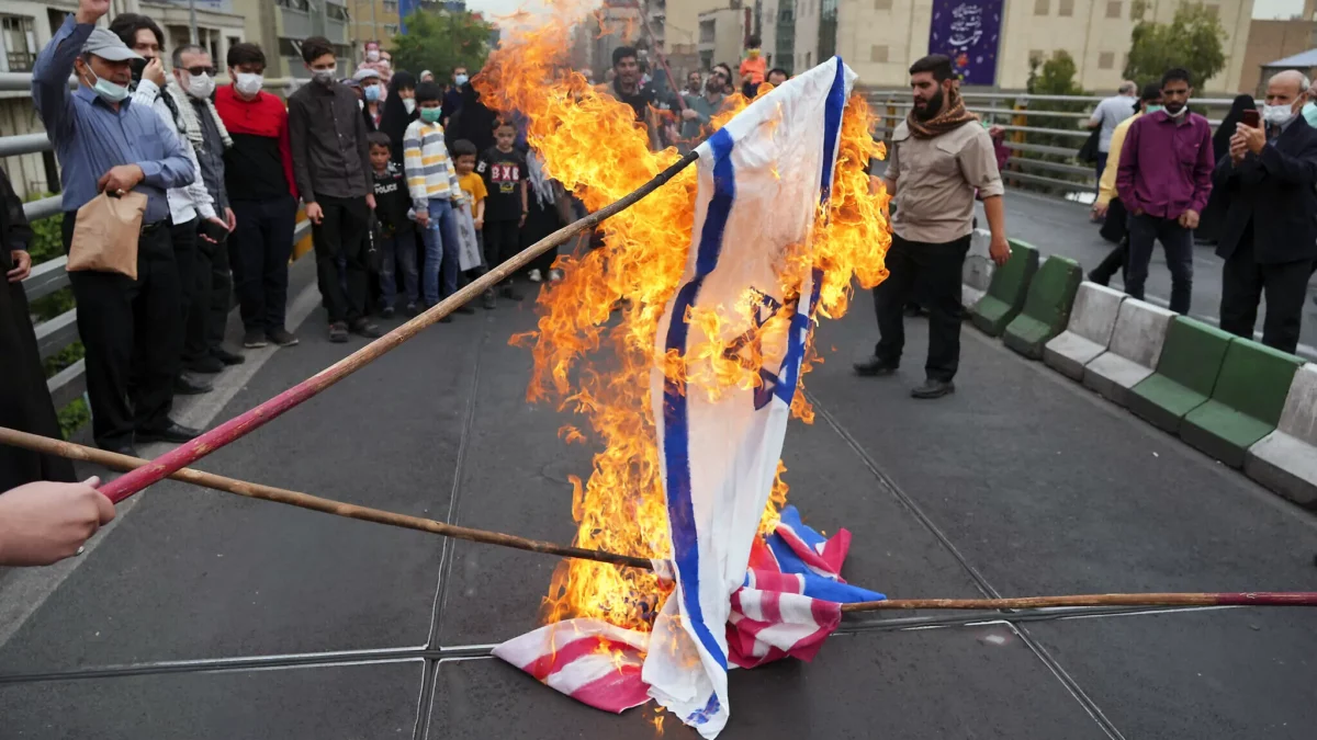 Iranians burn representations of Israeli, British and American flags during the annual Al-Quds Day demonstration in Tehran, Iran, April 29, 2022. (AP Photo/Vahid Salemi)