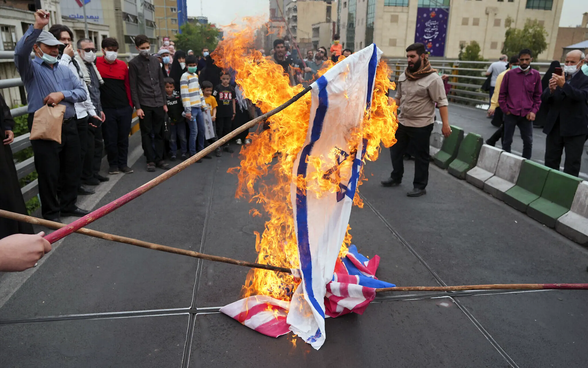 Iranians burn representations of Israeli, British and American flags during the annual Al-Quds Day demonstration in Tehran, Iran, April 29, 2022. (AP Photo/Vahid Salemi)