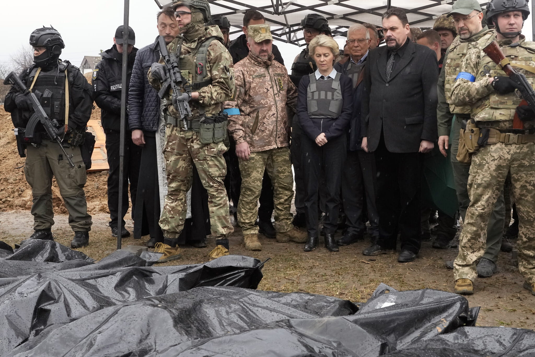 La presidenta de la Comisión Europea, Ursula von der Leyen, en el centro, observa los cuerpos cubiertos de civiles muertos en Bucha, en las afueras de Kiev, Ucrania, el viernes 8 de abril de 2022. (AP Photo/Efrem Lukatsky)