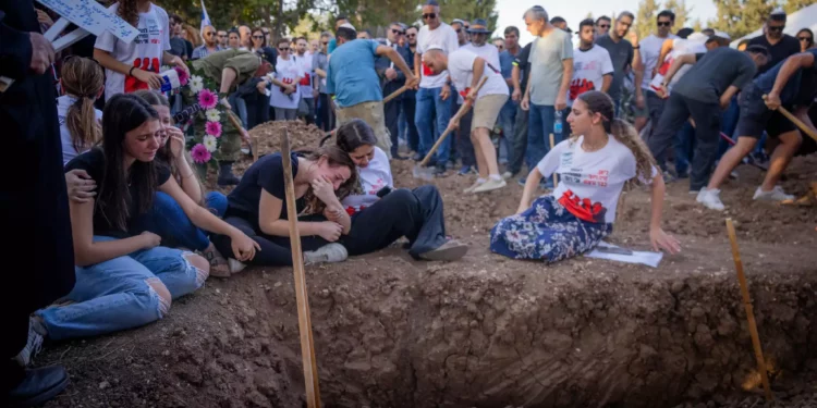 Familiares y amigos asisten al funeral de tres miembros de la familia Sharabi, Lian, Noya y Yahel, asesinados por terroristas de Hamás en el kibutz Be'eri el 7 de octubre de 2023, en Moshav Kfar HaRif, al sur de Israel, el 25 de octubre de 2023. (Chaim Goldberg/Flash90)