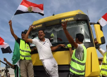 Egyptian aid workers celebrate as an aid truck crosses back into Egypt through the Rafah border crossing with the Gaza Strip on October 21, 2023. (Kerolos Salah/AFP)
Egyptian aid workers celebrate as an aid truck crosses back into Egypt through the Rafah border crossing with the Gaza Strip on October 21, 2023. (Kerolos Salah/AFP)