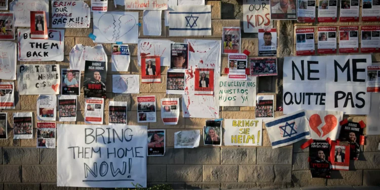 Posters calling for the release of hostages held by Hamas terrorists in Gaza, outside the Defense Ministry in Tel Aviv, October 21, 2023. (Miriam Alster/Flash90)