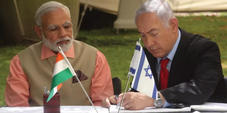 PRIME MINISTER of India Narendra Modi looks on during his 2017 visit to Israel as Prime Minister Benjamin Netanyahu signs a document of cooperation. (photo credit: MARC ISRAEL SELLEM/THE JERUSALEM POST)