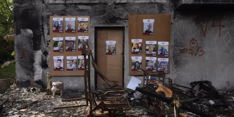 Fotografías de rehenes israelíes retenidos en la Franja de Gaza colocadas en una casa del kibutz Be'eri, Israel, 20 de diciembre de 2023. (AP/Ohad Zwigenberg)