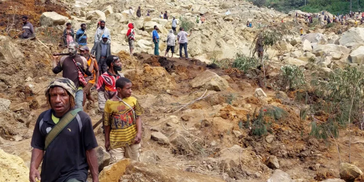 Locals gather at the site of a landslide at Mulitaka village in the region of Maip Mulitaka, in Papua New Guinea's Enga Province on May 26, 2024. (AFP)