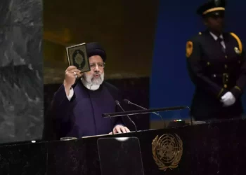 Iran’s President Ebrahim Raisi holds up a Quran as he addresses the 78th session of the United Nations general Assembly at United Nations headquarters, September 19, 2023. (AP Photo/Seth Wenig)