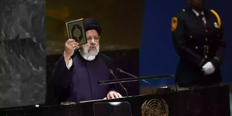 Iran’s President Ebrahim Raisi holds up a Quran as he addresses the 78th session of the United Nations general Assembly at United Nations headquarters, September 19, 2023. (AP Photo/Seth Wenig)