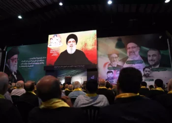 People gather to listen to a televised speech by Hezbolá Secretary general Hassan Nasrallah during a rally to mourn the recent death of the Iranian president Ebrahim Raisi and his entourage, killed in a helicopter accident, in Beirut's southern suburbs on May 24, 2024. (Anwar Amro/AFP)