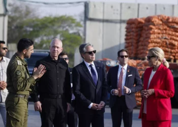 US Secretary of State, Antony Blinken, third right, stands between Defense Minister Yoav Gallant, third left, and UN Senior Humanitarian and Reconstruction Coordinator for Gaza, Sigrid Kaag, right, at the Kerem Shalom border crossing in Kerem Shalom, Israel, May 1, 2024. (Evelyn Hockstein/Pool Photo via AP)