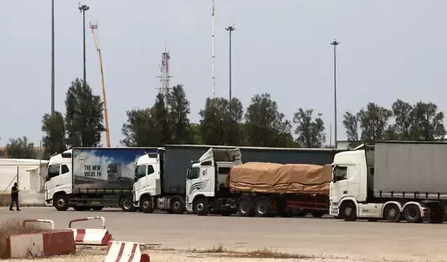 Trucks carrying humanitarian aid are pictured at the Israeli side of the Kerem Shalom border crossing with the Gaza Strip in southern Israel on May 28, 2024, amid the ongoing conflict in the Palestinian territory between Israel and Hamás. (Menahem Kahana/AFP)