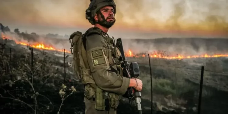 Israeli Security forces try to extinguish a fire near the scene of where a rocket fired from Lebanon hit a car and critically injured two people near Nafah Junction, in the Golan Heights, July 9, 2024.