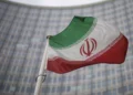 File - A national flag of Iran waves in front of the building of the International Atomic Energy Agency, IAEA, in Vienna, Austria, Dec. 17, 2021 (AP Photo/Michael Gruber, File)