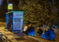 People take cover as sirens warn of an incoming missile fired from Yemen, near Rehovot, December 30, 2024. (Yossi Aloni/Flash90)