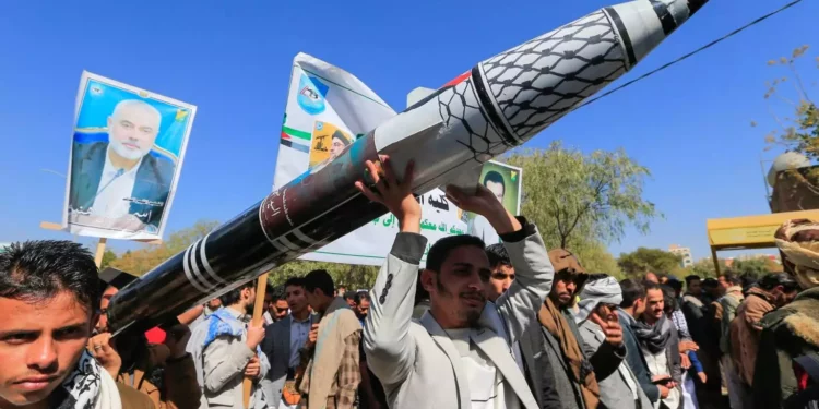 Hombres portan un misil simulado durante una manifestación de estudiantes universitarios y profesores que denuncian los ataques contra Yemen y en solidaridad con los palestinos, en la capital controlada por los hutíes, Saná, el 25 de diciembre de 2024. (Mohammed Huwais / AFP)