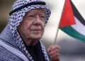 Jimmy Carter con kefiyeh y bandera palestina