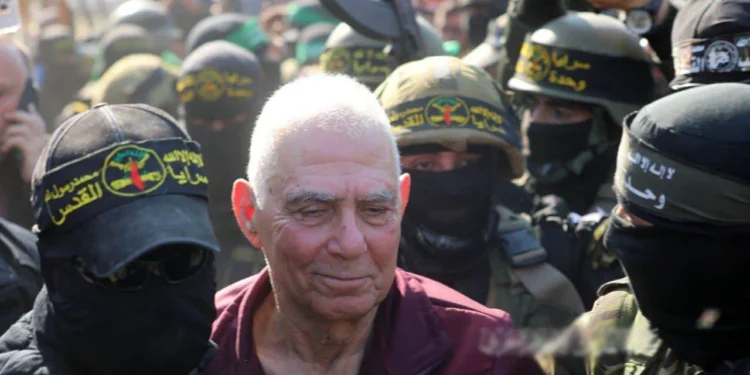 Gadi Mozes, de 80 años, rodeado de hombres armados durante su liberación del cautiverio en Jan Yunis, Gaza, el 30 de enero de 2025 (a través de las redes sociales)