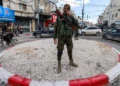 A member of the Palestinian Authority security forces stands at a traffic circle in the Jenin refugee camp, in the northern West Bank, December 29, 2024. (Jaafar Ashtiyeh/AFP)