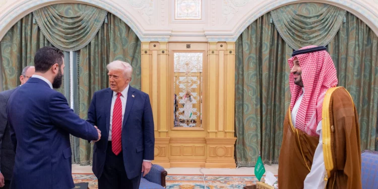 US President Donald Trump shakes hands with Syrian President Ahmad al-Sharaa as Saudi Crown Prince mohammad Bin Salman looks on, in Riyadh, May 14, 2025. (Saudi Royal Palace)