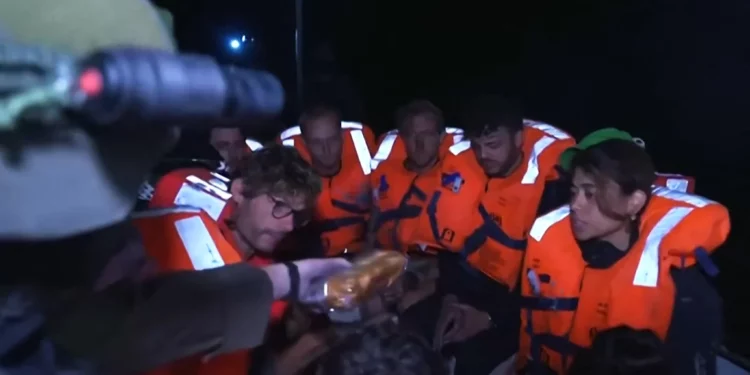 Activistas a bordo del barco de ayuda Madleen con destino a Gaza reciben sándwiches tras ser interceptado por fuerzas israelíes en aguas internacionales. (Captura de pantalla/Ministerio de Asuntos Exteriores de Israel vía AFP)