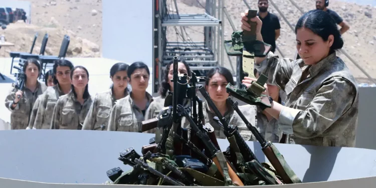 Combatientes kurdos del PKK queman sus armas en una ceremonia de desarme en Irak