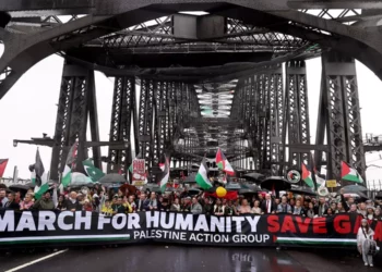 Manifestantes cruzan el puente del puerto de Sídney durante una manifestación propalestina y antiisraelí, el 3 de agosto de 2025. (David GRAY / AFP)