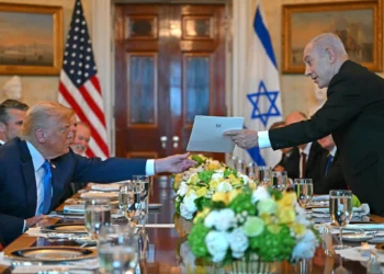 Israeli Prime Minister Benjamin Netanyahu (R) hands over a letter to US President Donald Trump as they meets at the Blue Room of the White House in Washington, DC, on July 7, 2025. (Photo by ANDREW CABALLERO-REYNOLDS / AFP)