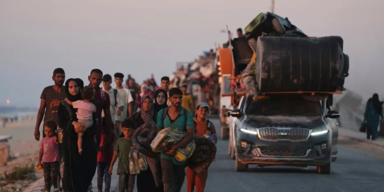 Displaced Palestinians fleeing northern Gaza carry their belongings along the coastal road toward southern Gaza, Sept. 13, 2025, after the Israeli army issued evacuation orders from Gaza City. (AP Photo/Jehad Alshrafi)